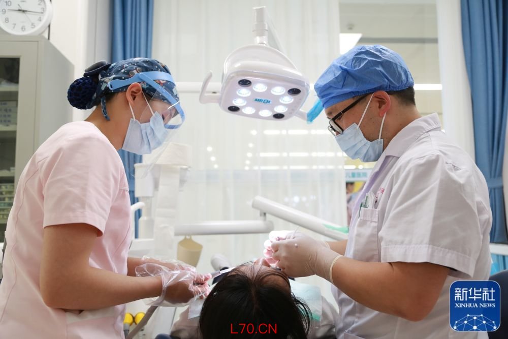↑ 5月2日，在位于云南省蒙自市的红河州妇幼保健院证券账户，口腔科医护人员为青少年治疗牙齿。新华社发（薛莹莹 摄）